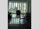 Bright living and dining area of light coloured marble flooring